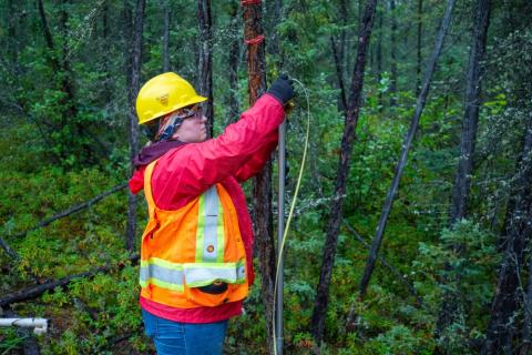 src summer student collecting water samples at abandoned mine site