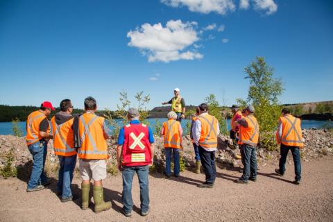 src tours community leaders and members around the gunnar mine