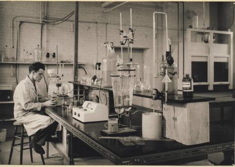 Lab worker sits at a bench in a uranium lab