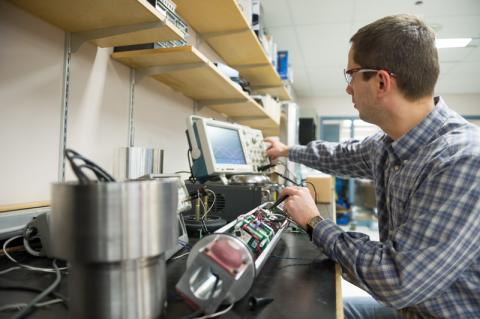 engineer works on custom equipment