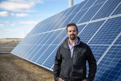 SRC engineer in front of solar panel array