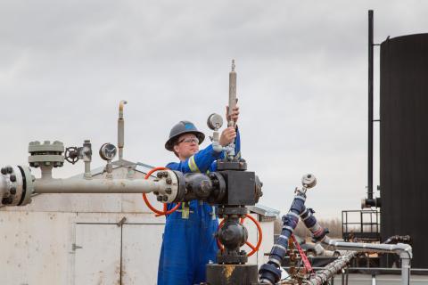 Engineer checks well-head at a post-chops site